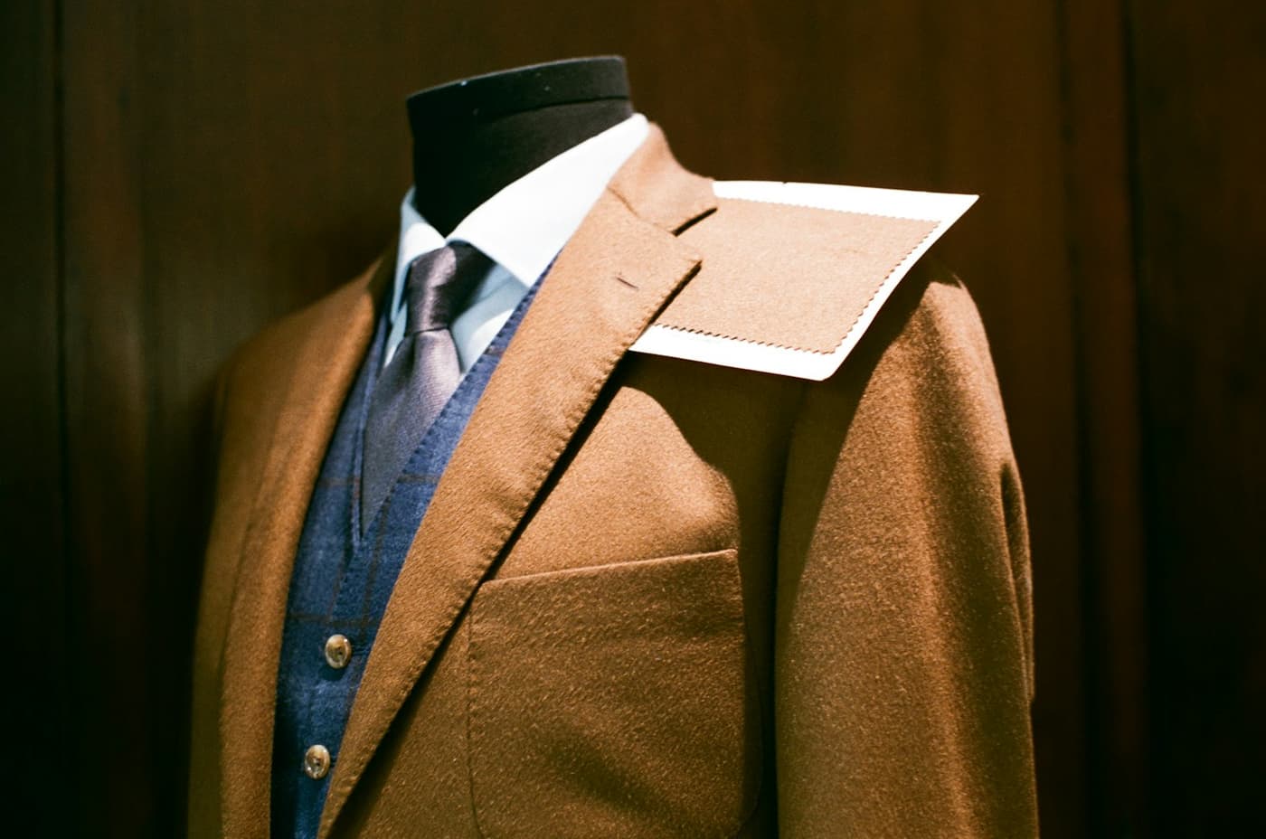 Suit and tie pinned on a tailor's mannequin during fitting
