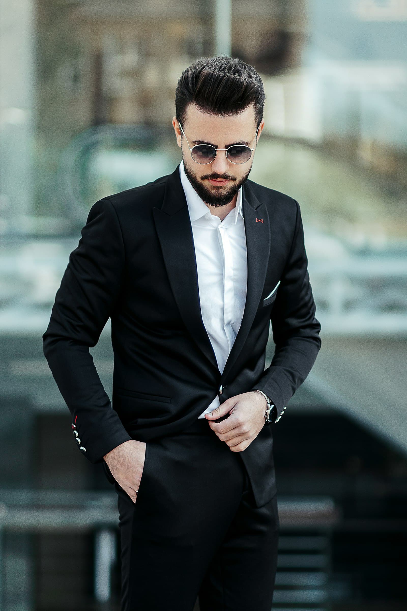 Groom in a black peak-lapel suit with crisp white shirt